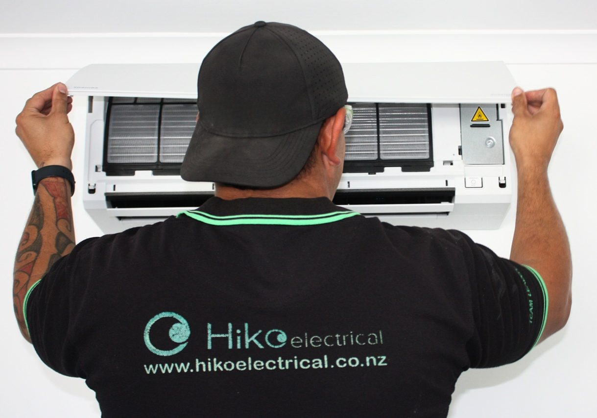 A Hiko Air technician servicing a heat pump.